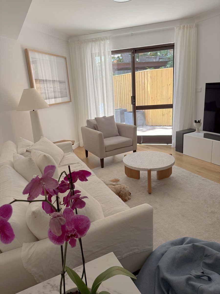 After: the living room, with oak floors and linen curtains