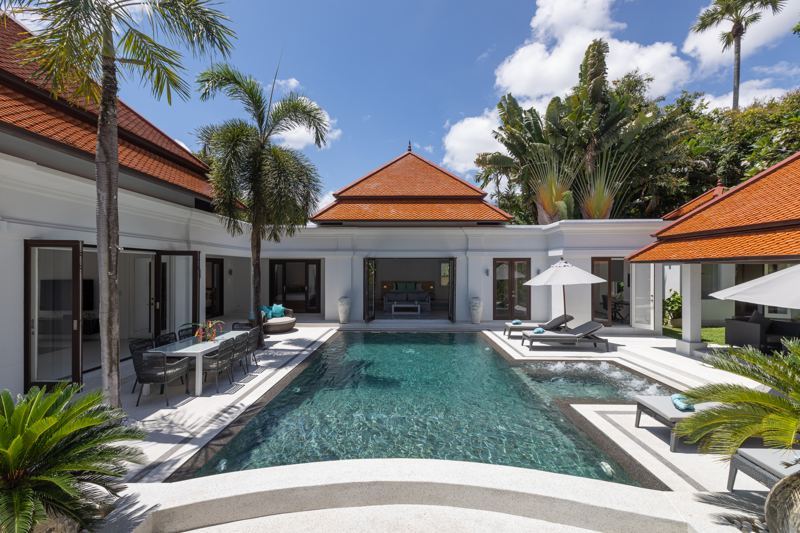 Pool and courtyard view of the renovated villa by day