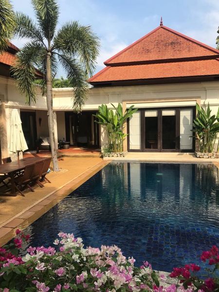 Before: the courtyard and pool, with terracotta paving and dark-framed doors