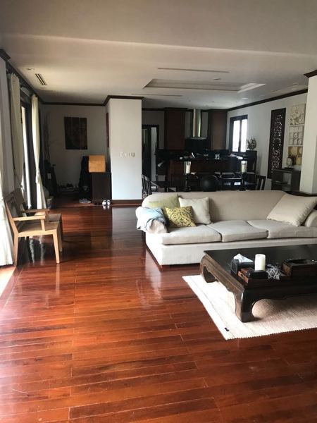 Before: the living room, with dark polished floorboards and timber trim
